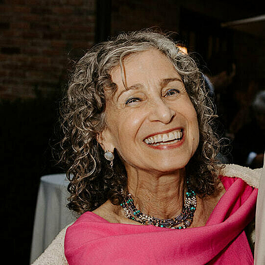 A women in pink smiles at camera