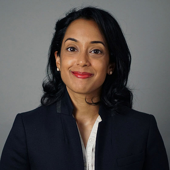 Portrait of women in blazer against grey background
